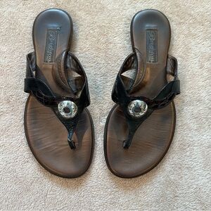 Brighton brown patent and black flip flops with silver embellishment.
